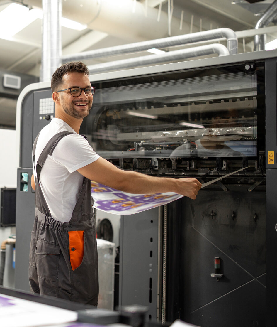 worker-taking-imprint-from-modern-printing-machine-color-matching-quality-control