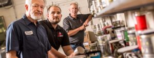 three-dynagraphics-workers-looking-at-the-camera