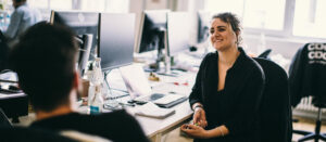 People talking at computers
